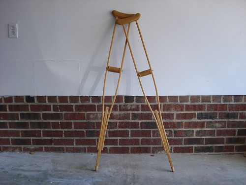 Photo of wooden crutches leaning up against a wall